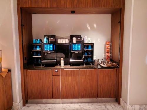 a barber shop with two chairs and two computers at Hôtel de la Paix Lausanne in Lausanne