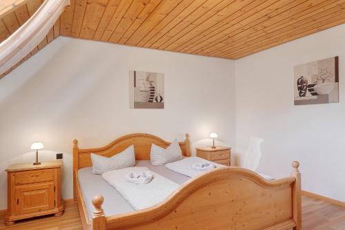 a bedroom with a wooden bed with two night stands at Vogtadeshof in Wolfach