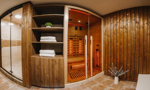 a wine cellar with wooden walls and a walk in closet at Chaty v Ráztoke in Veľké Borové