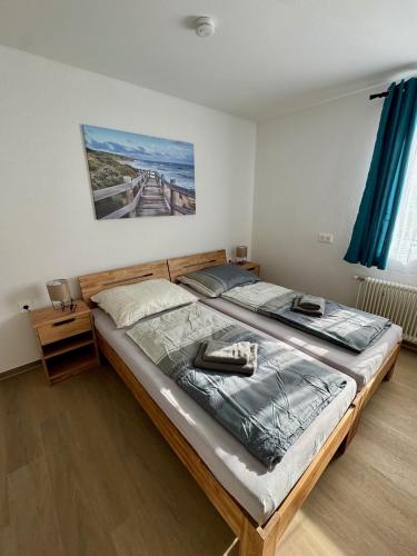 a large bed in a bedroom with blue curtains at Stadtquartier Völkermarkt in Völkermarkt