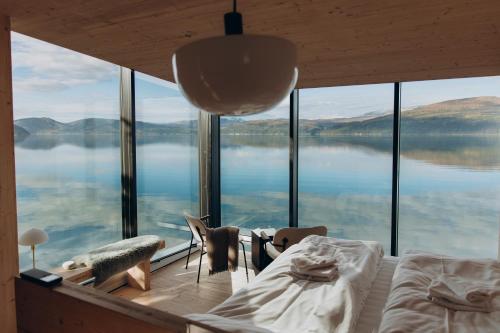 a bedroom with a large view of a lake at Yttervik in Mo i Rana