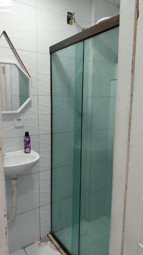 a glass shower in a bathroom with a sink at Vista da praça Castro Alves in Salvador