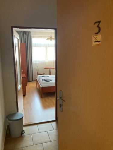 a door leading to a room with a bedroom at Penzion U Radnice in Kyjov