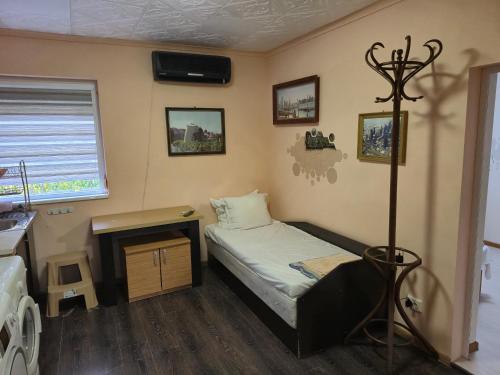 a small bedroom with a bed and a fireplace at Guest House Valchanovi in Elkhovo