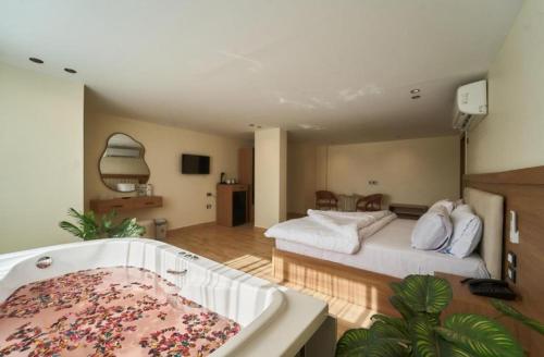 a large bedroom with a tub and a bed at pYramids View in Cairo