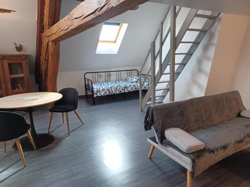 a living room with a couch and a staircase at Beaugency-3 sur la route des châteaux in Beaugency