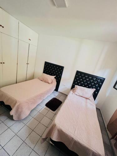 a room with two beds in a room at Casa con pileta y quincho in San Martín