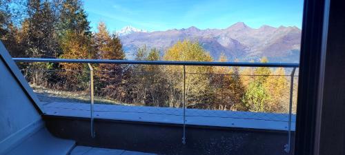 a balcony with a view of trees and mountains at White Relax in Pila