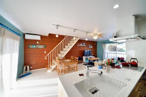 een keuken en een woonkamer met een trap op de achtergrond bij Manazuru ALOHA - Vacation STAY 12678v in Manazuru