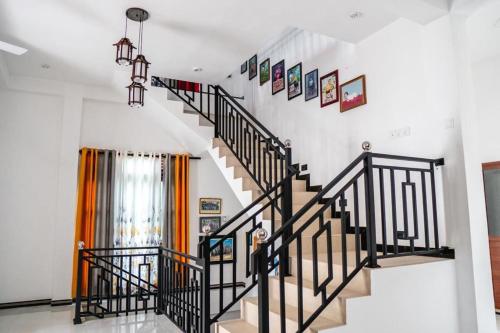 a staircase with black railings in a house at Tropical Haven Villa in Wellawatta