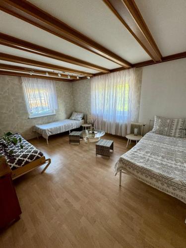 a large room with two beds and a couch at Rosental Privatunterkunft in Sankt Margareten im Rosental