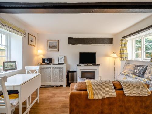 a living room with a couch and a desk and a television at No18 - Uk48248 in Sturminster Newton