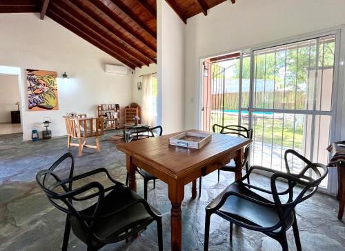 a dining room with a wooden table and chairs at Encanto Rural Keen in Luján