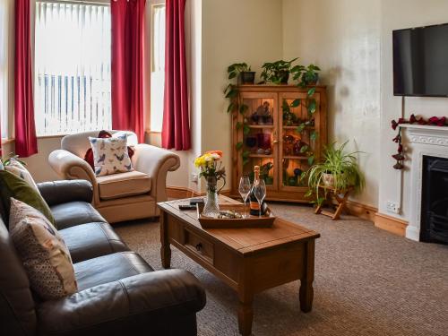 a living room with a couch and a coffee table at St Judes in Mundesley