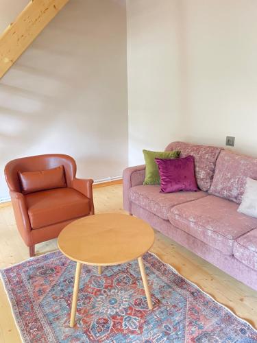 a living room with a couch and a chair at 2 Floor Rustic Inn in Dilijan in Dilijan