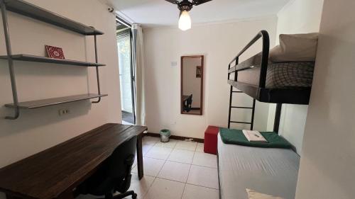 a small room with a bunk bed and a bench at Casa Ibirapuera - Hospedagem in Sao Paulo