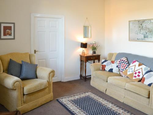 a living room with two chairs and a couch at Marley's Retreat in Seaton Delaval