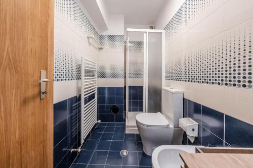 a bathroom with a toilet and a shower at Casa Slucca in Pellizzano