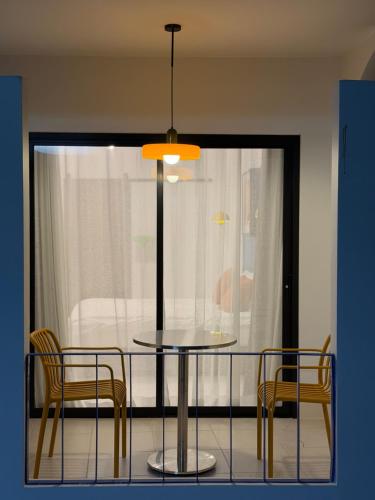 a dining table with two chairs and a table with a lamp at The Lamoon Residence samui in Lamai