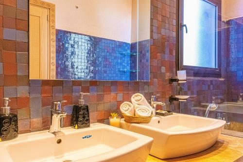 a bathroom with a sink and a tub and a sink at Luxury Villa - Pool Atlas Views & Wakeboard Lake in Marrakech