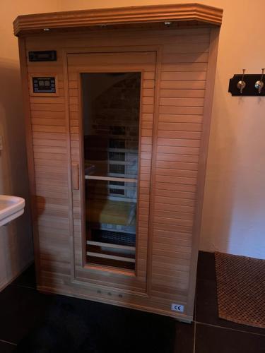 a wooden closet in the corner of a bathroom at Vakantiewoning Fruitschuur de Morel in Venlo