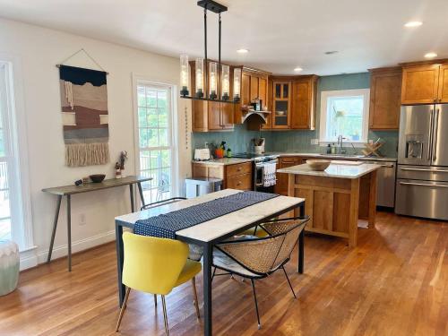 a kitchen with a table and yellow chairs in it at Peaceful 3BR on 5 acres - Minutes from Nashville in Joelton