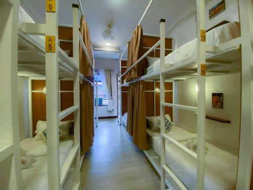 a hallway with four bunk beds in a room at Sanga Rooftop Hostel in Pakse