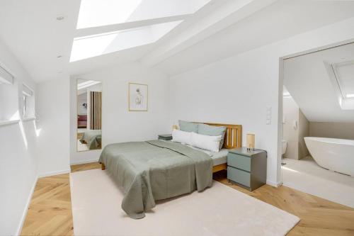 a bedroom with a bed and a tub and a sink at Luxury house with exclusive views in Vallendar