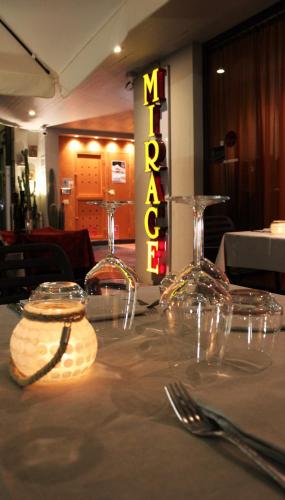 a table with silverware and a sign that reads m restaurant at Hotel Mirage in Viareggio