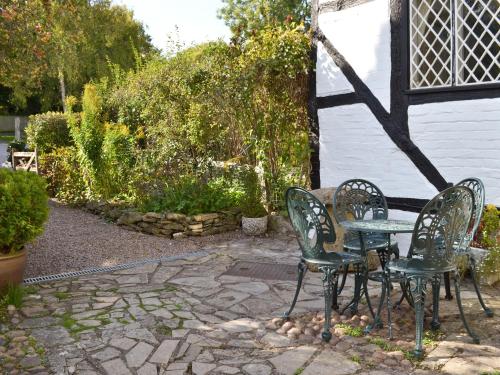 a patio with two chairs and a table at Hathaway Hamlet in Stratford-upon-Avon