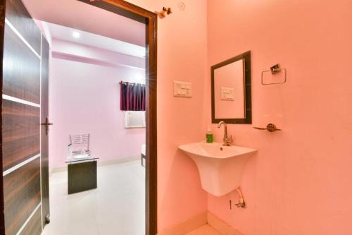 a bathroom with a sink and a shower at Magadh Imperial Guest House in Patna