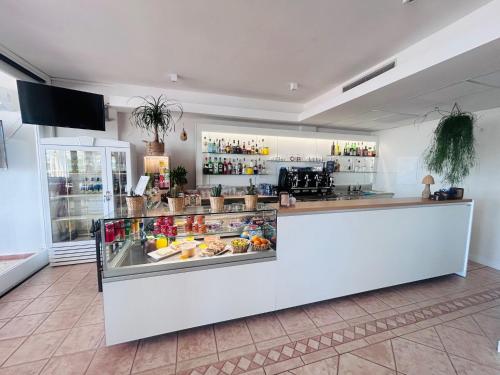 a food counter in a store with food behind it at Hotel Miralonga in La Maddalena