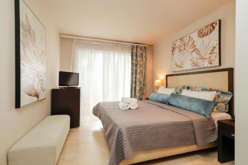 a bedroom with a large bed and a window at Alkyonis Hotel in Nea Kalikratia