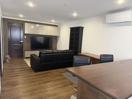 a living room with a couch and a television at Self-Contained Studio in Eagleby