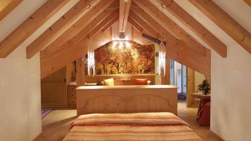 a bedroom with a large bed in a attic at Hotel Sass Maor in Fiera di Primiero