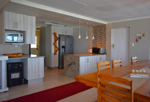 a kitchen and dining room with a table and a dining room at C 4Ever Unit 1 and 2 in Groot Brak Rivier