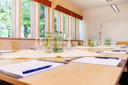 a classroom with bottles and pens on tables at Waldhotel Vogtland in Klingenthal