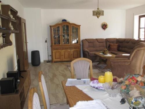 een woonkamer met een tafel en een bank bij Fehaus Johannesberg in Waltershausen