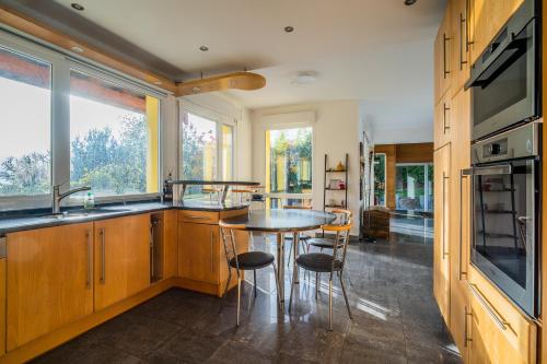 a kitchen with a table and some chairs in it at Castle view terrace - Swimming pool - Air conditioning in La Vancelle