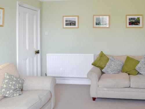 a living room with two couches and a radiator at Hillcrest in Pickering