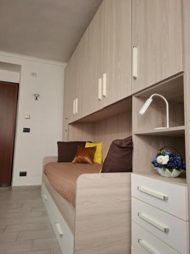 a bedroom with a large bed in a room at La Casa Del Borgo in Torre Pellice