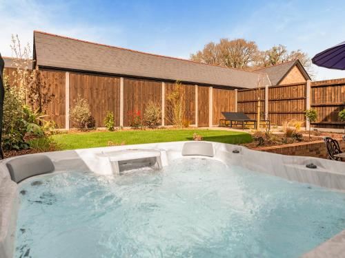 a hot tub in the backyard of a yard at Old Barn 1 - Uk48477 in Ferndown