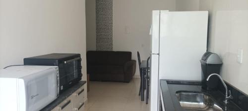 a kitchen with a microwave and a refrigerator at Casa Sol in Prado