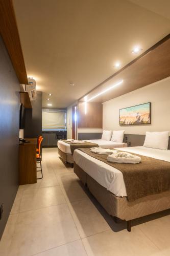 a hotel room with two beds in a room at Easy Porto Hotel in Porto De Galinhas