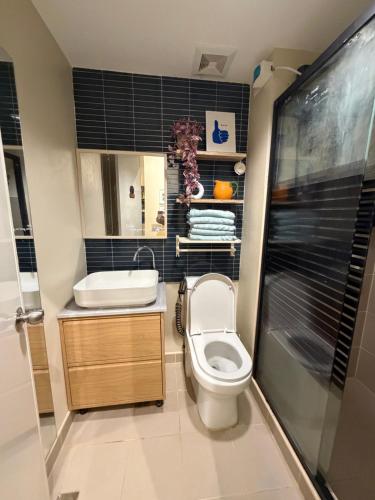 a small bathroom with a toilet and a sink at The Bleu Mansion Iligan in Iligan