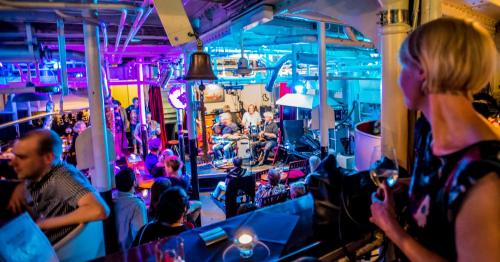 a group of people sitting in a bar at Das Feuerschiff in Hamburg
