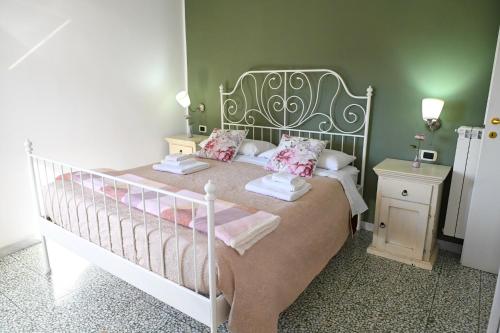 a bedroom with a white bed with pink pillows at B&B Borgo Sciugolo in Baselice