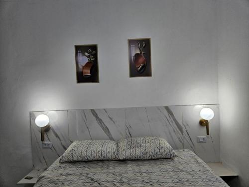 a bedroom with a bed and three pictures on the wall at Pousada Gaturama Village in Corumbá