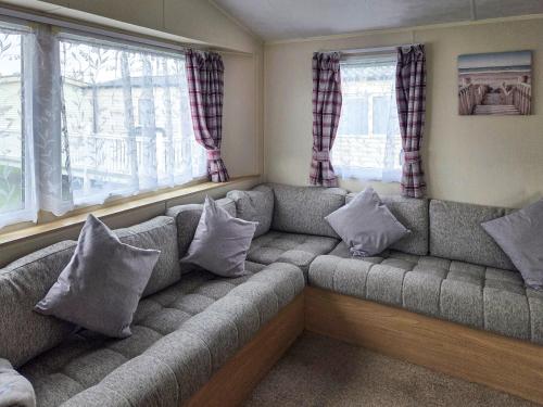 a couch in a living room with pillows on it at Waterlily in Lancaster