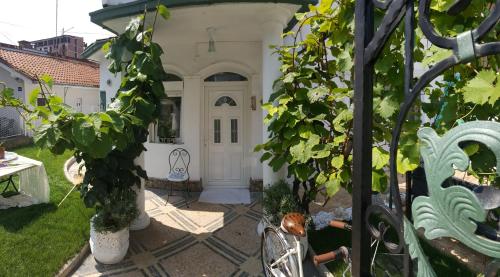a house with a white door and some plants at French House in Belgrade